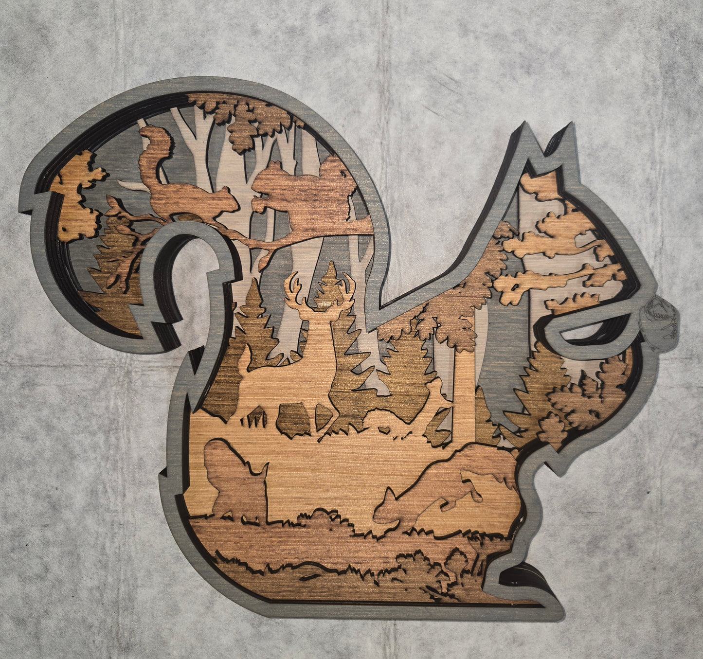 Multi-layered wall art that transcends traditional display limitations. This versatile multi-layered Squirrel functions seamlessly as a standalone accent for tables, countertops, and mantles, or mounts elegantly on walls for dramatic visual impact. Crafted with dimensional layering that creates depth and sophistication, it adapts to any interior design scheme. Whether you're seeking a focal point for a shelf, a statement piece above a fireplace, or a gallery wall installation, this art delivers professional