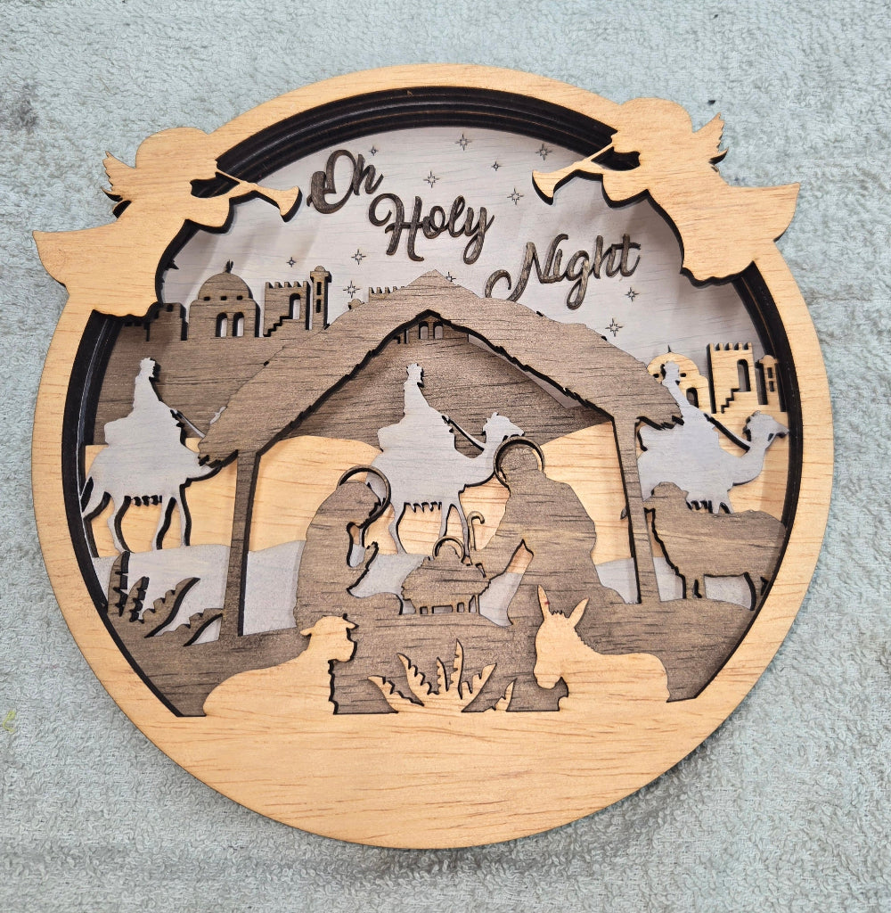Wooden Nativity Christmas decoration 6-Layered scene  with 'Oh Holy Night' text on a gray background