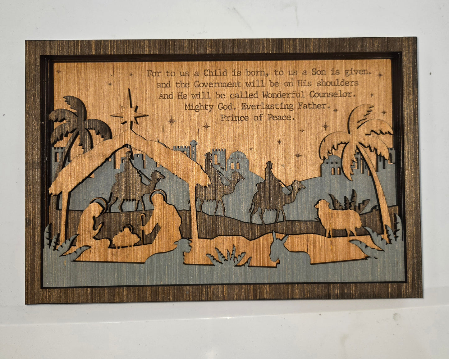 Wooden Nativity Christmas decoration 6-Layered scene cutout&nbsp; with 'Prince Of Peace' text on a gray background

L x W x H = 11in x 1.25in x 7.25in