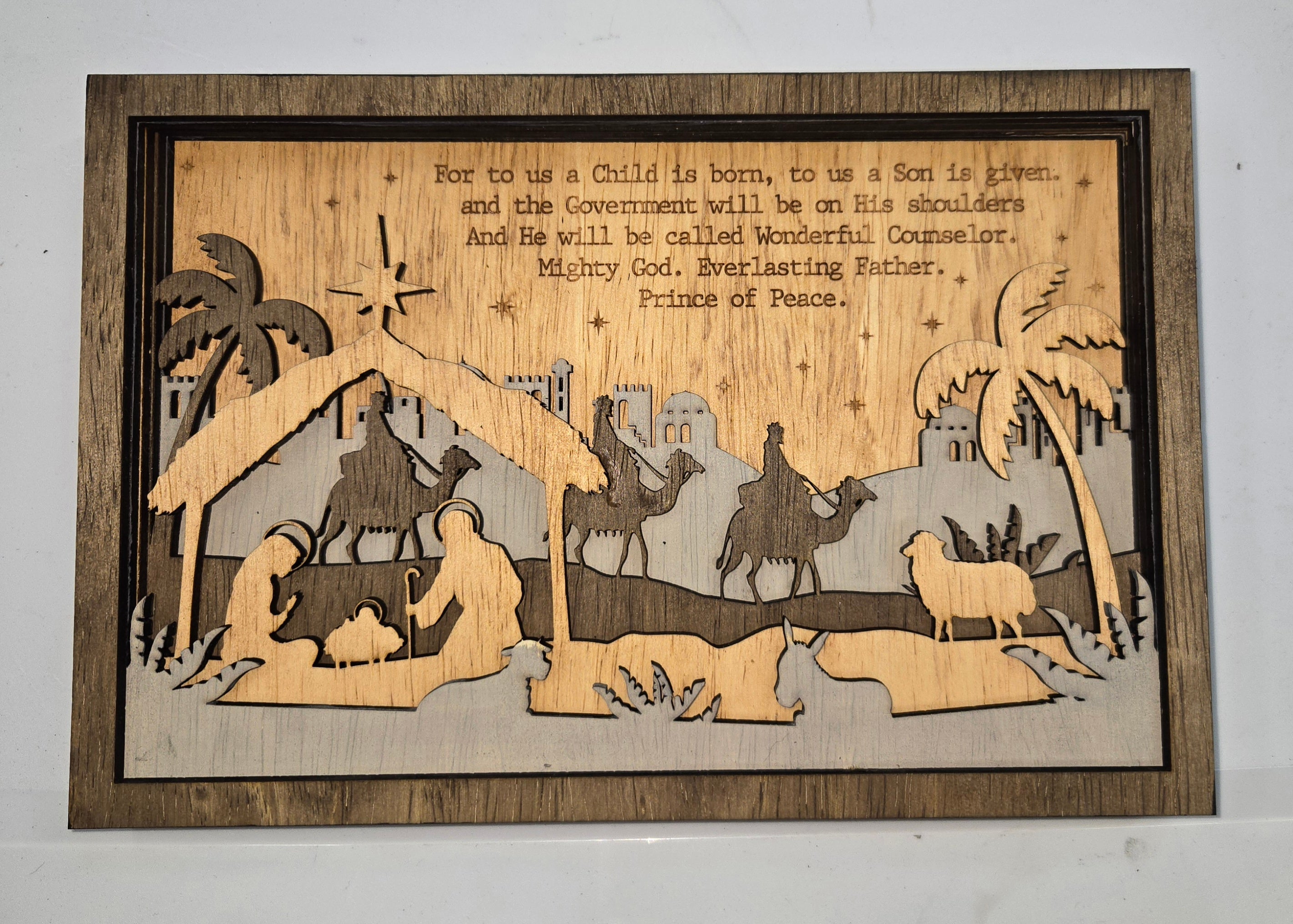 Wooden Nativity Christmas decoration 6-Layered scene cutout&nbsp; with 'Child Is Born' text on a gray background

L x W x H = 11in x 1.25in x 7.25in