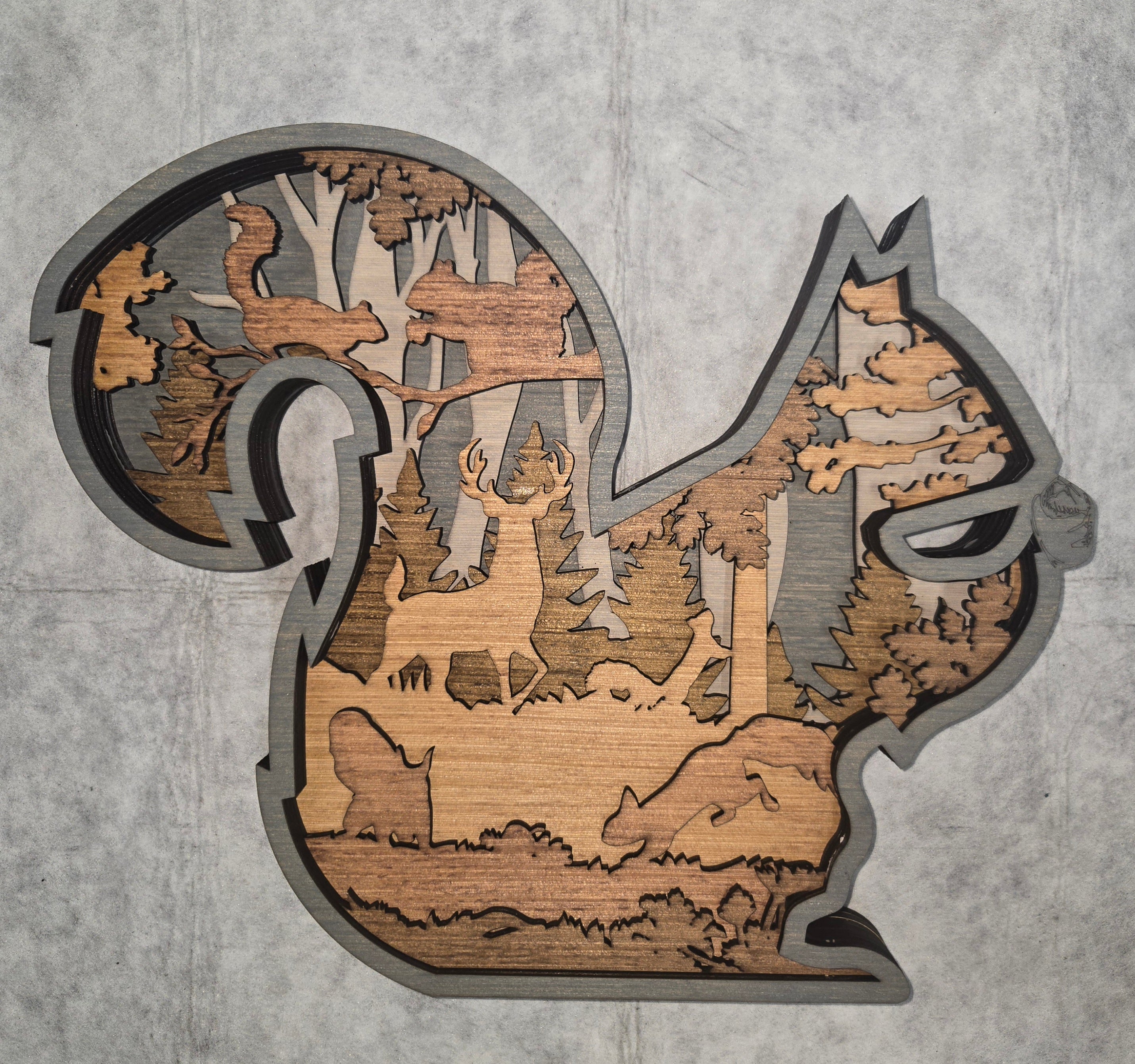 Multi-layered wall art that transcends traditional display limitations. This versatile multi-layered Squirrel functions seamlessly as a standalone accent for tables, countertops, and mantles, or mounts elegantly on walls for dramatic visual impact. Crafted with dimensional layering that creates depth and sophistication, it adapts to any interior design scheme. Whether you're seeking a focal point for a shelf, a statement piece above a fireplace, or a gallery wall installation, this art delivers professional